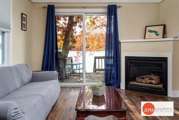 A living room with a sofa, a wooden coffee table, and a fireplace.