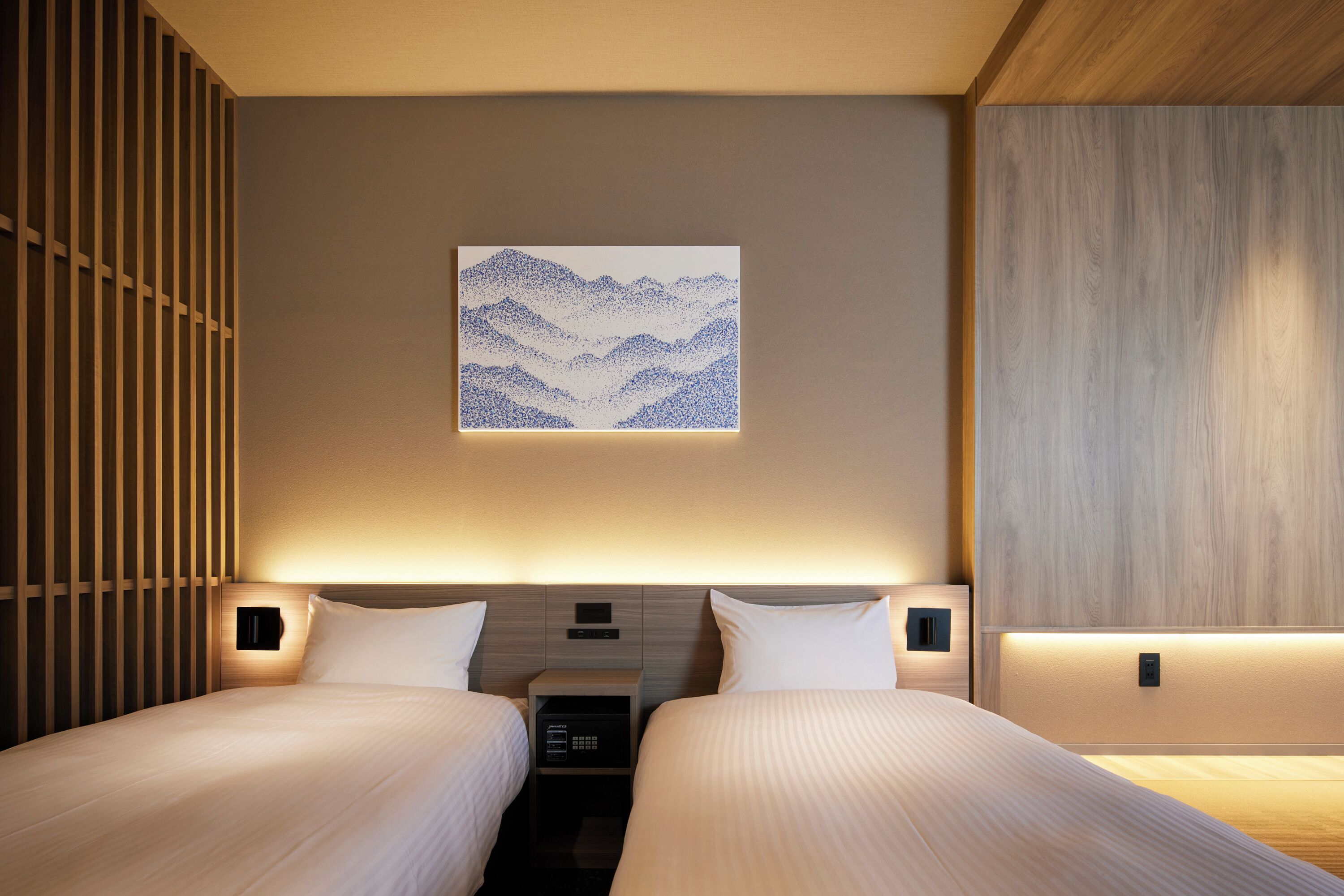 A hotel room with two beds, a wall-mounted artwork, and a wooden panel design.
