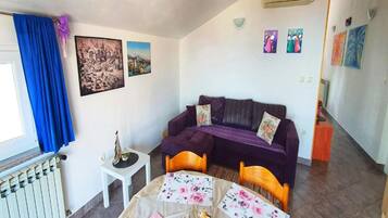 Apartment (One Bedroom Apartment) | Living room | 32-inch flat-screen TV with satellite channels