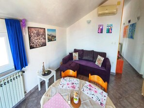 Apartment (One Bedroom Apartment) | Living room | 32-inch flat-screen TV with satellite channels