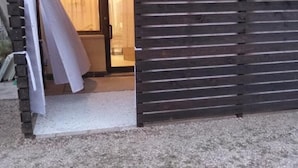 A wooden gate leading to a building with a visible interior. - LaBandaBassottiFerrara  (Monestirolo)