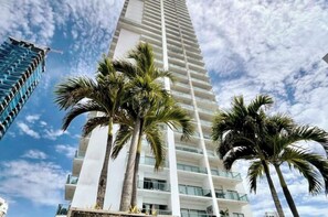 A tall, modern high-rise building with a white facade and multiple balconies. - Panoramic High-Rise Oceanview Condo in Bocagrande (Bocagrande)