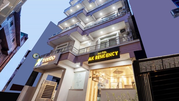 A modern building with a sign for 'Hotel AK Residency' and 'Treebo'. - Treebo AK Residency (Rishikesh)