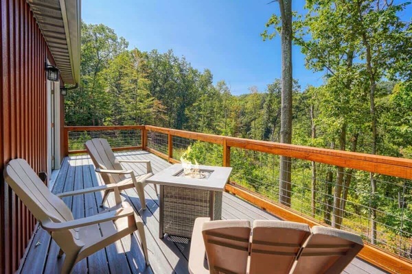 Deck: Sip drinks by the fire while immersed in serene woodland views and fresh air!