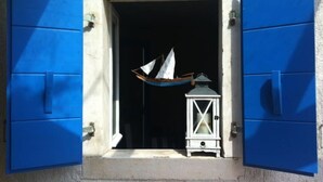A window with blue shutters, a small boat model, and a white lantern inside. - House IVAS - Umag  (Zambratija)