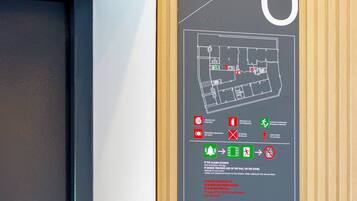 Letrero en la pared con planta de pisos e instrucciones de emergencia para la habitación 6.