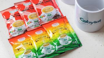 Instant coffee and tea packets on a countertop.