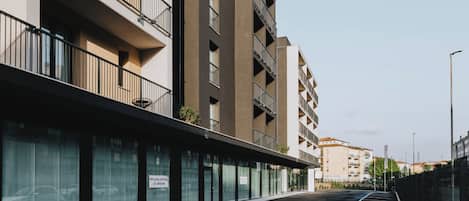 A multi-story parking garage with a modern design, featuring a flat roof and a series of balconies on the upper floors.