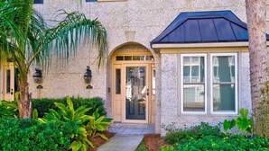 A building with a stone facade, a front entrance with a door, and a window with a dark roof. - 1035 Beachview Dr in Saint Simons Island, GA (Saint Simons Island)