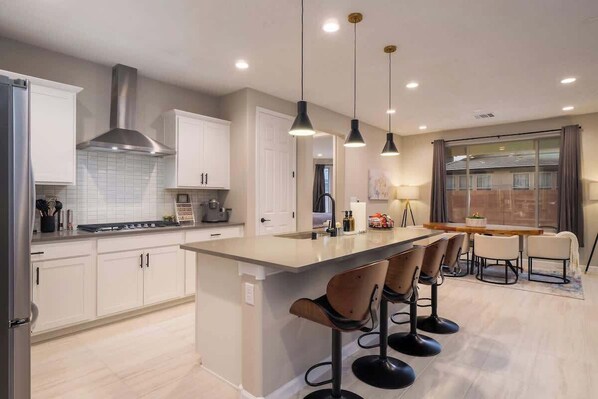 Fridge, dishwasher, coffee/tea maker, cookware/dishes/utensils