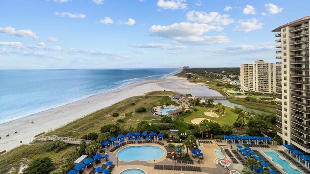 A resort with multiple swimming pools, a beach, and high-rise buildings. - A Dream Stay by the Waves: 3-Bedroom Condo with King and Queens (North Myrtle Beach)
