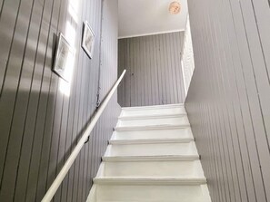 A staircase with white handrails and wooden walls. - 7 Person Holiday Home in Horn (Horn)