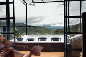 A room with a large window overlooking a mountainous landscape. - Green Oriental Resort (La Vega)