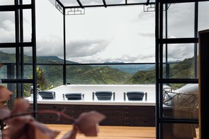 Una habitación con un ventanal amplio que da a un paisaje montañoso.