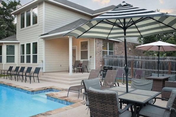 A house with a swimming pool, outdoor seating, and a covered patio area. - Arcade, Billiards with a non heated Pool Two master suites (San Antonio)