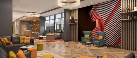 A modern lobby with a large seating area, a chandelier, and a striped wall design.