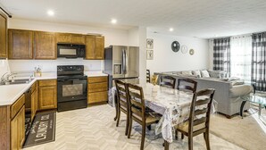 A modern kitchen with wooden cabinets, a built-in microwave, and a stainless steel refrigerator. - 16 Mi to Louisville: Pet-friendly Getaway! (Shepherdsville)