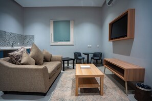 Family Apartment | Living area | 50-inch Smart TV with satellite channels - Holiday Plus Tabba Apartments (Madinah)