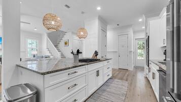 Coffee/tea maker, toaster, ice maker, dining tables