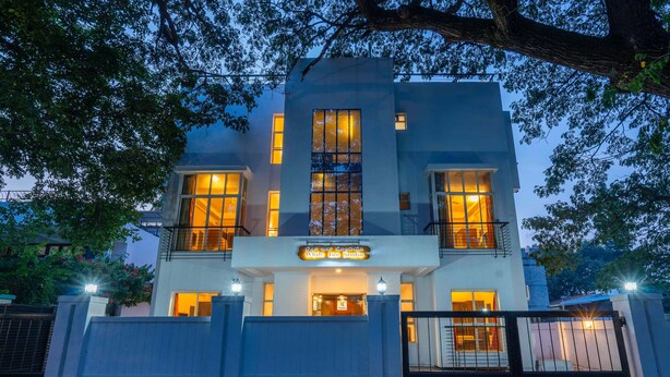 A modern building with a sign reading "White Inn Studio." - Treebo Ivory White Inn (Bengaluru)