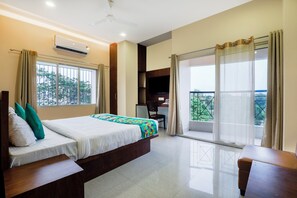 Deluxe Double Room | Desk, blackout drapes, iron/ironing board, bed sheets - Treebo Urban Oasis Inn, Sixmile (Guwahati)