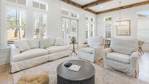 A spacious living room with a sectional sofa, two armchairs, a round coffee table, and a chandelier. - Seagrove Home + Golf Cart, Private Pool & Bikes (Santa Rosa Beach)