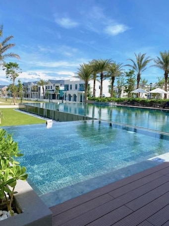 Outdoor pool, pool umbrellas, pool loungers. PRS Golf Villa
