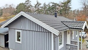 A small, single-story building with a grey exterior and a tiled roof. - 4 Star Holiday Home in Svanesund (Svanesund)