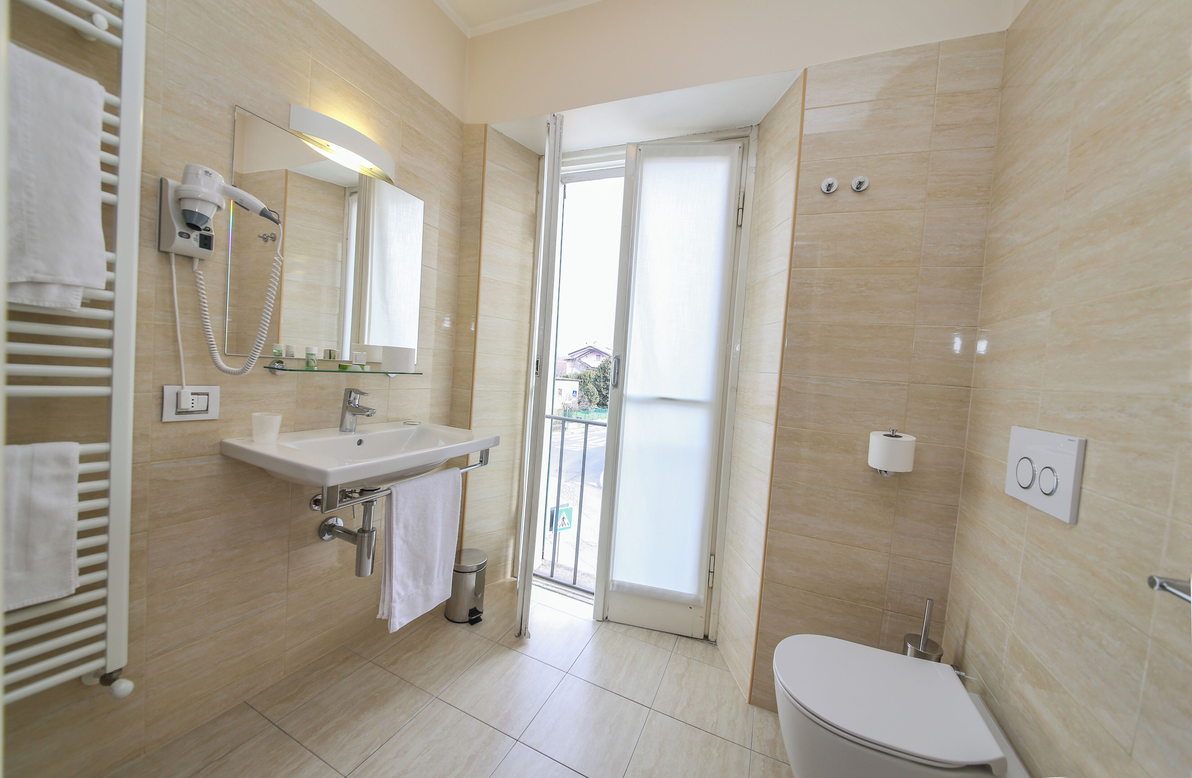 A modern bathroom with a sink, mirror, and toilet.