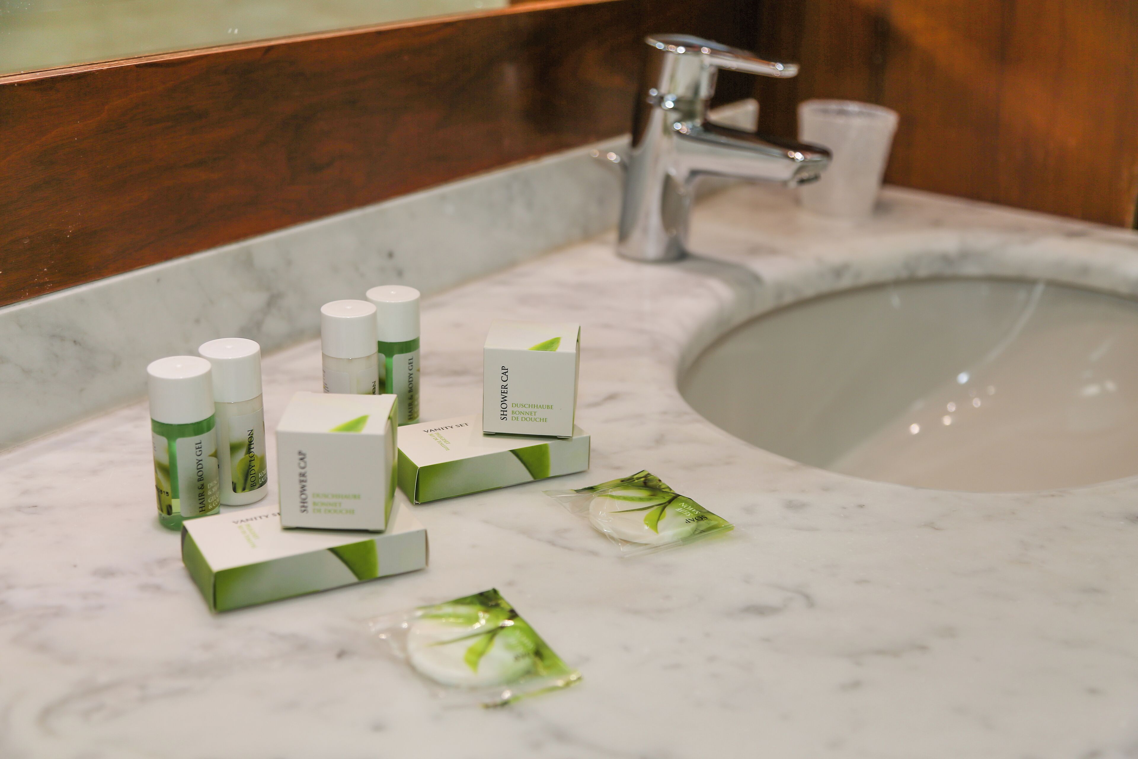 A bathroom sink with toiletries and a mirror.