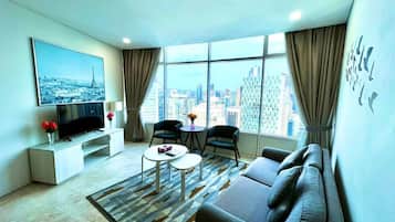 Family Apartment, City View | Living area | Flat-screen TV