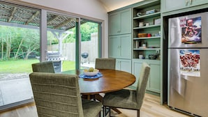 A kitchen with a dining table, chairs, a refrigerator, and a view of the outdoors. - 4 Mi to Texas A&M! Cozy Home Away From Home (College Station)
