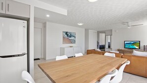 A modern kitchen with white cabinets and a built-in LG refrigerator.