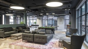 A modern lounge area with sofas, a pool table, and a billiards table. - Modern Apartments in Hollis Croft Sheffield (Sheffield)