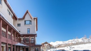 A hotel with a traditional architectural style, featuring a prominent balcony and a mountain view in the background. - Shirana #1/#7 5 Bedroom Plus Loft (Mountain Village)