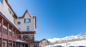 A hotel with a traditional architectural style, featuring a prominent balcony and a mountain view in the background. - Shirana #1/#7 5 Bedroom Plus Loft (Mountain Village)
