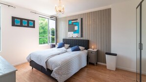 A bedroom with a bed, bedside tables, a trash bin, a mirror, and a window. - Magnificent Holiday Home for 6 Adults in Xhoffraix (Malmedy)