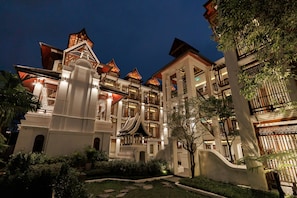 A multi-story hotel with traditional architectural elements, including tiered roofs and ornate balconies. - Akira Thaphae Hotel (Chiang Mai)