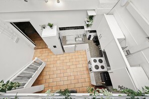A compact kitchen with a built-in stove, a sink, and a small countertop.