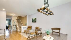 A dining area with a wooden table, two chairs, a bench, and a hanging light fixture. - Townhome 3 Mi to Wescott Park & Golf Course! (Ladson)