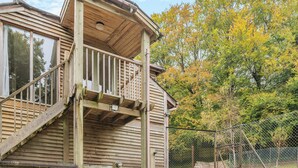 A wooden house with a balcony and a fenced yard. - Casa BowWow - UK48047 (Rudry, near Cardiff)