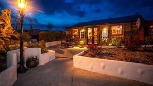 A wooden building with a porch, a street lamp, and a well-maintained garden. - The Hideaway Muff - Private estate, Shebeen, Lough Foyle (Muff)