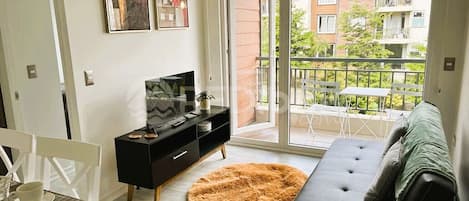 Comfort Apartment | Living area | 32-inch flat-screen TV with digital channels