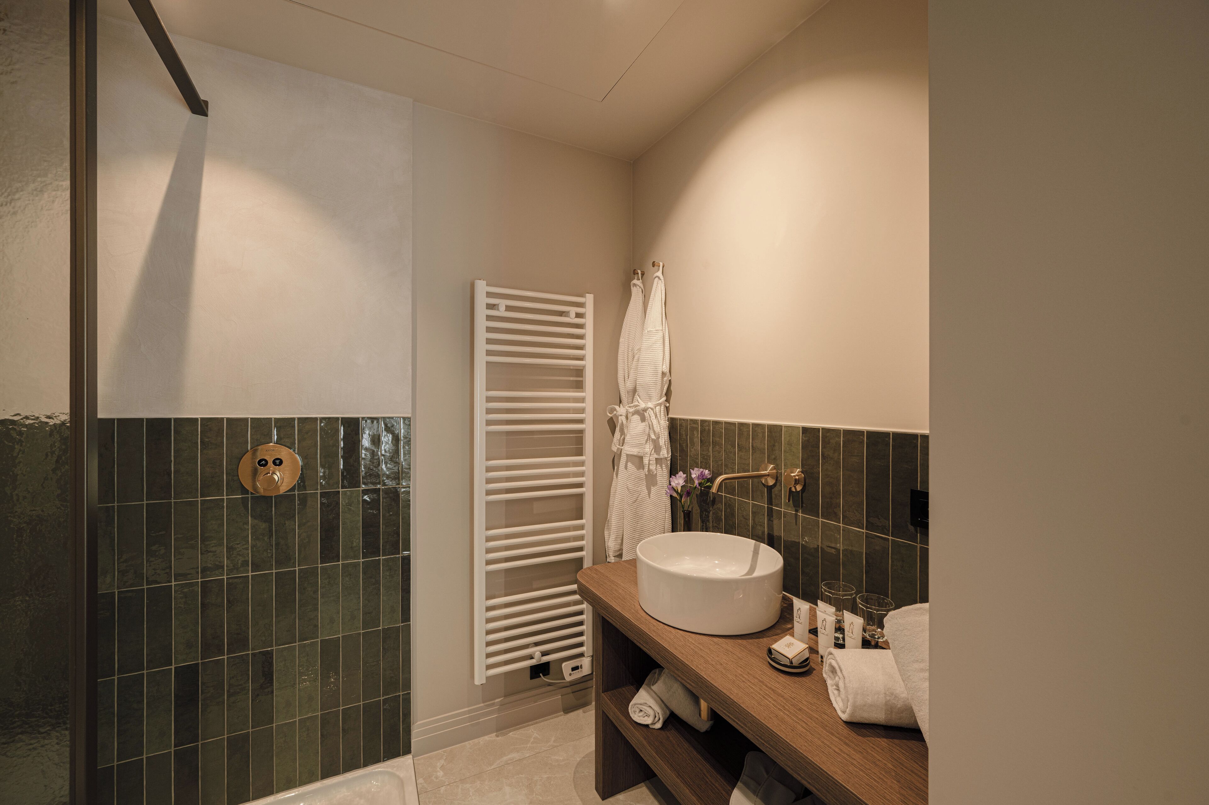 A bathroom with a bathtub, a sink, and a towel rack.