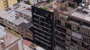 A multi-story building with a modern architectural design, featuring balconies and large windows. - New y modern apto In Virrey (Bogotá)