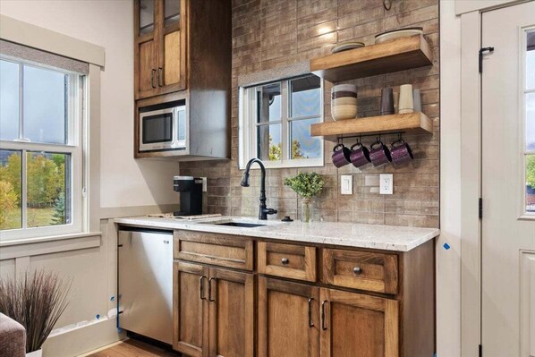 Fridge, microwave, coffee/tea maker, cookware/dishes/utensils