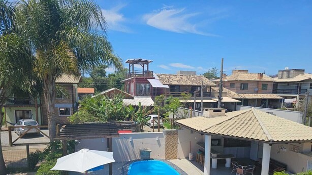 Ein Wohngebiet mit Swimmingpool, Terrassenmöbeln und einem Pavillon.
