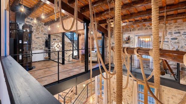 A spacious interior with stone walls, wooden beams, and rope decorations. - Holiday Home 'Masia Can Divi' with Mountain Views, Wi-Fi and Air Conditioning (Ametlla del Valles)