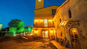 A building with a tower, a balcony, and a staircase leading to the entrance. - Holiday Home 'Masia Can Divi' with Mountain Views, Wi-Fi and Air Conditioning (Ametlla del Valles)