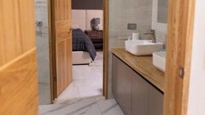 A modern bathroom with a wooden vanity, a sink, and a mirror. - Luxurious Getaway w Private Pool Garden (Santiago)